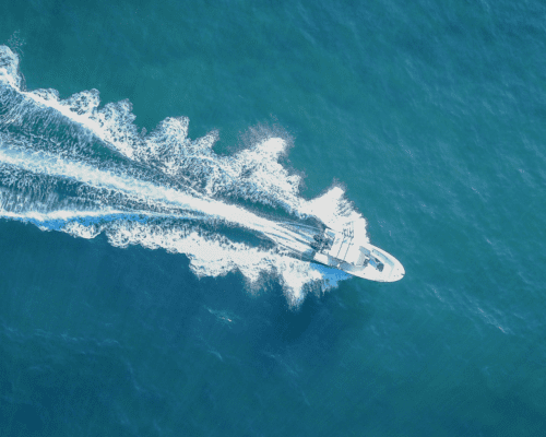 A boat making its way through blue water.